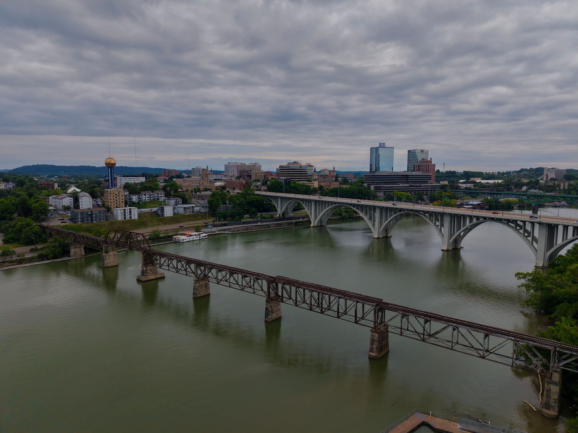 Junk removal near Knoxville: downtown Knoxville skyline with the Sunsphere and bridges over the Tennessee River on a cloudy day